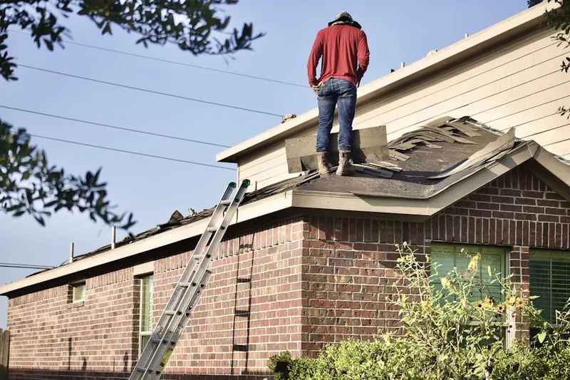 Professional roofer working on a residential roof in Newberry